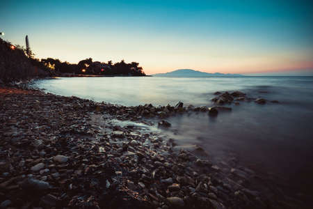 sea waves on the stone beach at sunset, landscape, Zakynthos, Greeceの写真素材