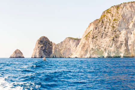Cruise around Zakynthos, landscape view from the sea on the island, Greece. small motor boat rocking by wavesの写真素材