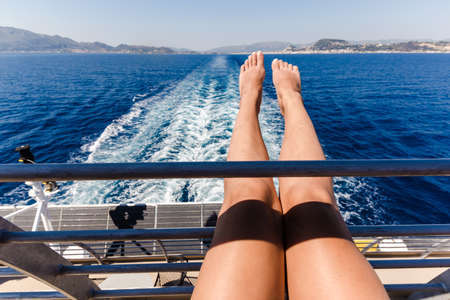 sexy young woman legs relaxing on cruise ship travel holiday.の写真素材