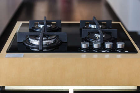 modern kitchen built-in cooker on wooden stand, close up photo, Shallow DOFの写真素材