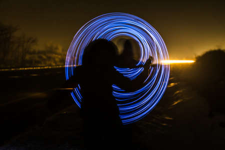 blur or defocuset abstract pgoto of artistic light on long exposure with a girl in winter clothes in...