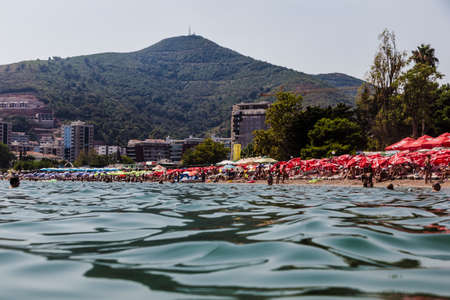 24 august 2017 view from the sea to the beach and mountains in Budva, Montenegroのeditorial素材