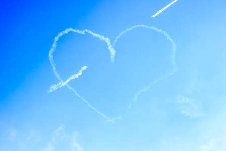 Heart formed by airplanes against the blue skyの写真素材