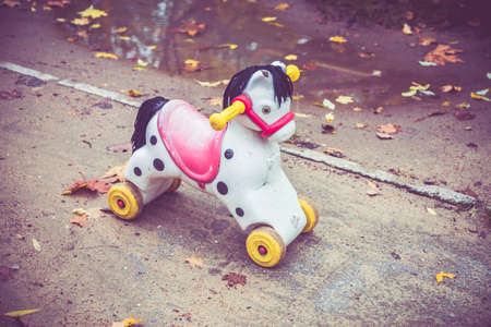 abandoned toy horse in the autumn in a forgotten city
