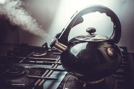 Dirty boiling kettle on the stove