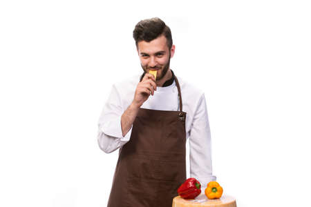 funny chef bites cheese, isolated on white backgroundの写真素材