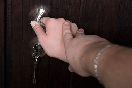 The couple opens the entrance door, in a new apartmentの写真素材