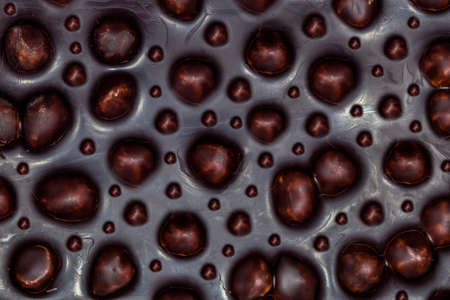 background image of dark chocolate with a lot of nutsの写真素材