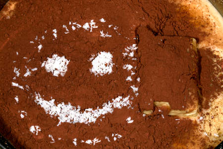 on cocoa powder muzzle with smiles from coconut shavings, background imageの写真素材