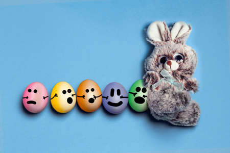 Easter bunny with painted eggs with drawing muzzle, go in a row with a train, Easter card