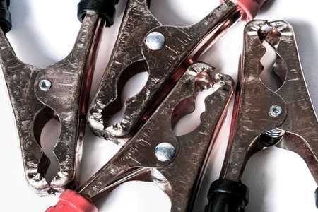 battery jumper cables on white background, close-up clamps