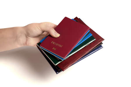 a lot of documents in the hand in the foreground of a passport, photo on a white backgroundの写真素材