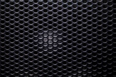 photo of a close-up of a musical column hidden behind a grid with a pattern of rhythmically arranged holes, background imageの写真素材