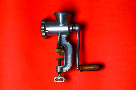 ordinary old meat grinder on a red background, flat lay imageの写真素材