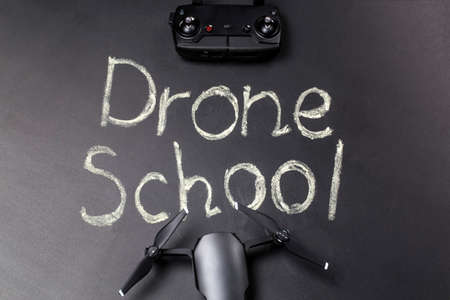 chalkboard inscription on the blackboard  drone school, near quadrocopter and its accessories