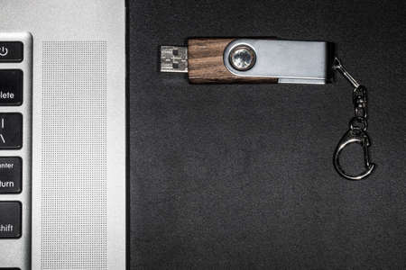 wooden flash drive near a laptop, close-up, background imageの写真素材