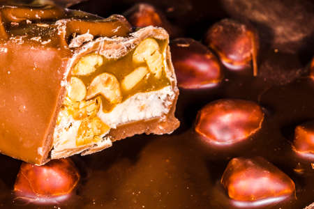 cut piece of chocolate with nuts, close-up , background imageの写真素材