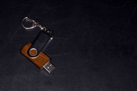 wooden flash drive on a chalkboard with space for text, background imageの写真素材