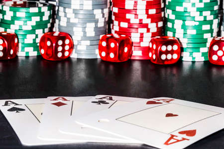 a composition of chips, game bones and four aces, with space for text, a screensaver for the casino