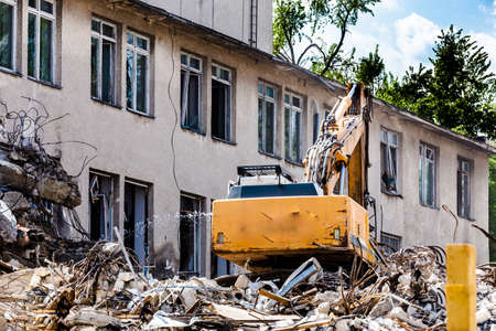 demolition of a building with a hydraulic excavator