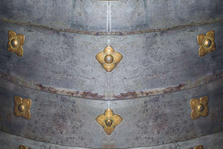 metal armor decorated with decorative metallic flowers, close-up photoの写真素材