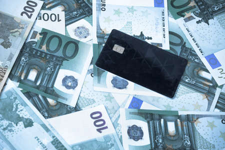 bank cards against the background of cash (euros), toned image