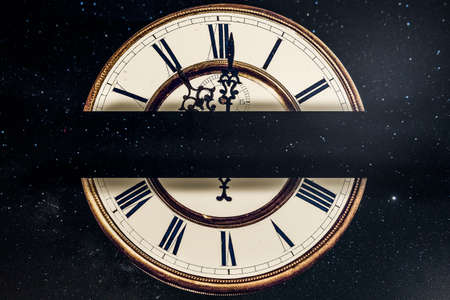 old clock with Roman numerals on a background of a starry sky with a place for text on the centerの写真素材