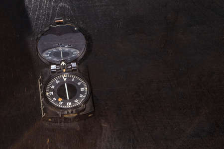 old compass on a wooden brown background with space for textの写真素材