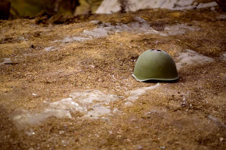 damaged helmet on the battlefield, background image