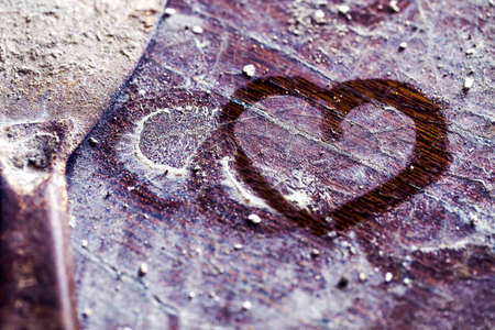 heart on the picture on a wooden dusty background, the concept of love repair, toned imageの写真素材