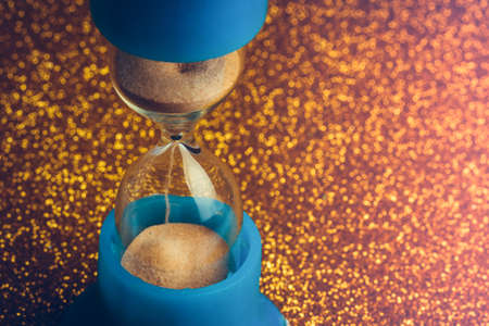 hourglass on gold glitter, toned background image, concept time of money or golden time with space for textの写真素材