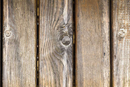 background of wooden boards, vertical texture of a fence with space for textの写真素材
