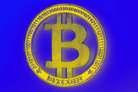 golden bitcoin on blue background, closeup photoの写真素材
