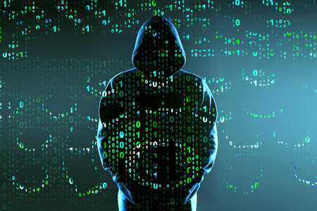 binary code on the background of the silhouette of a hacker in the hood, the concept of cyber attack