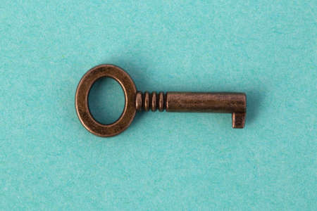bronze key on azure paper, background image