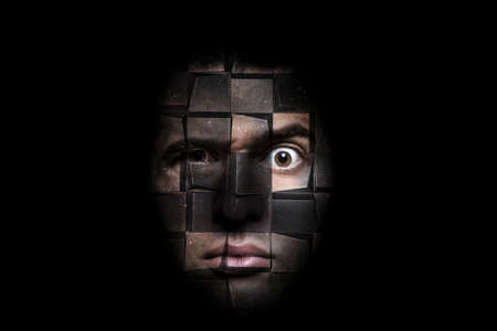 portrait of a man with a puzzled look that decomposes into cubes, concept of roboticsの写真素材