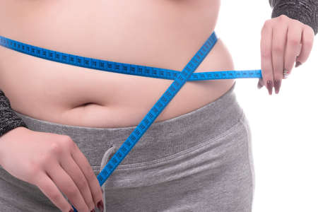 plus size woman measuring waist isolated on white backgroundの写真素材