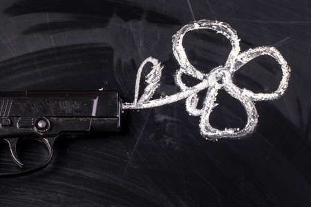 a gun that shoots a flower near to the inscription there is no warの写真素材