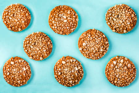 oatmeal cookies with cereals and seeds on azure surface, background imageの写真素材