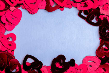 frame from plastic decorative hearts on a blue backgroundの写真素材