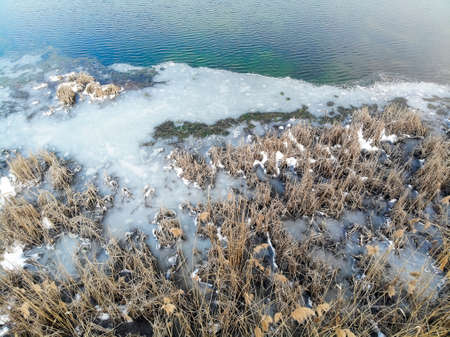 aerial view of the shore of a frozen lake