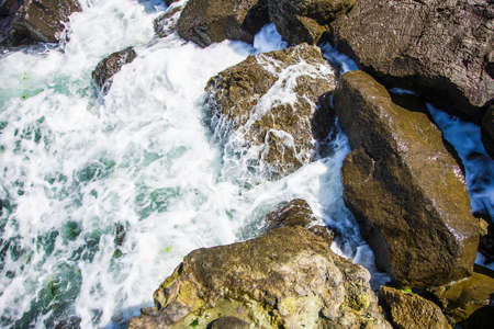 image of stones in the sea with waves, aerial view