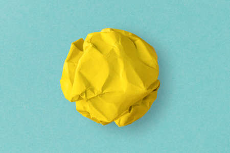 yellow crumpled paper on a blue backgroundの写真素材