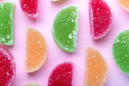 colored fruit jelly with sugar crystals, on a pink backgroundの写真素材