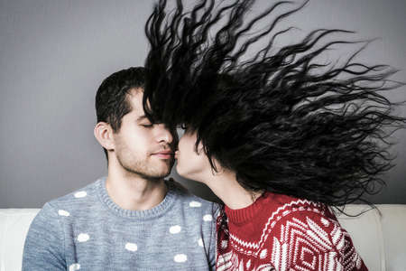 Young couple in love have fun i on new year's eve or st valentine's day on gray backgroundの写真素材