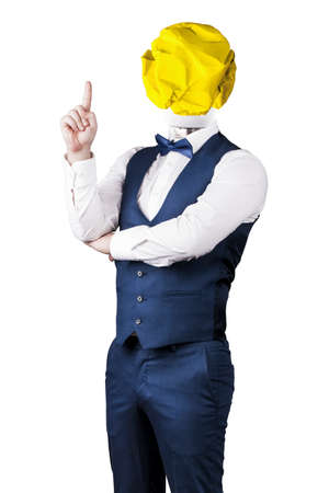 a man isolated on white background in a suit with a light bulb of crumpled yellow paper instead of a head with a raised finger, the concept of the ideaの写真素材