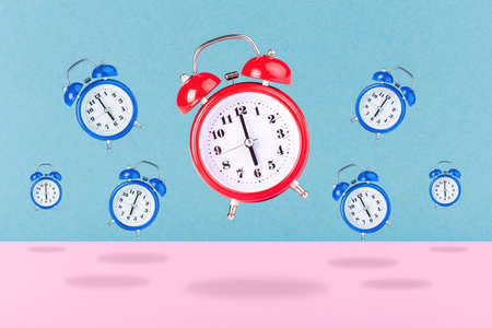 background of red and blue alarm clocks