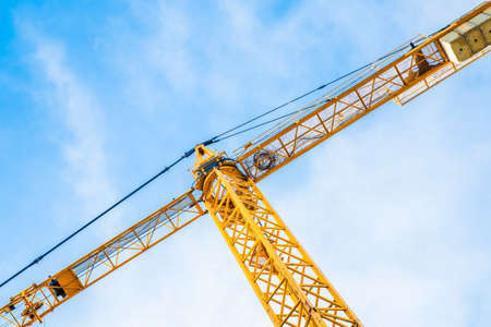 yellow crane against the blue sky