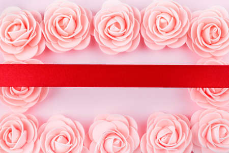 decorative pink roses in the shape of a frame with a red ribbon on top, mockupの写真素材