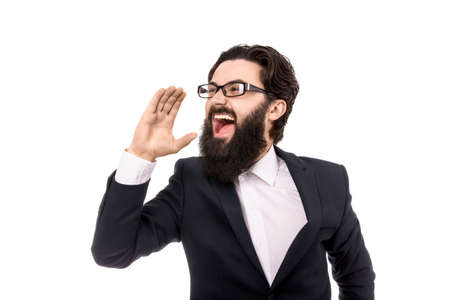 businessman shouting and holding hand near the mouth, isolated on white backgroundの写真素材